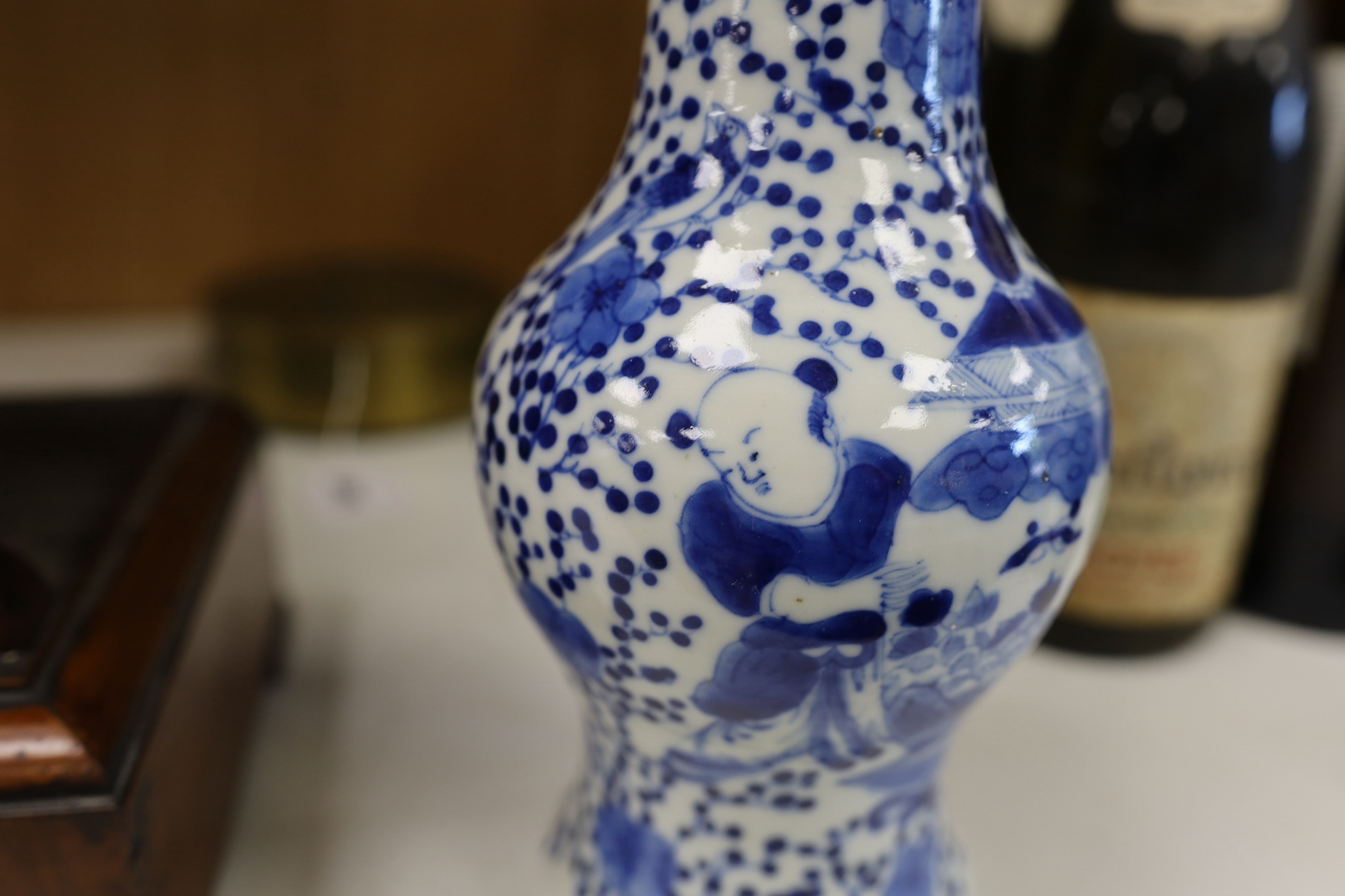 A Chinese blue and white 'boys' bottle vase, Kangxi mark but 19th century, 26cm high. Condition - good